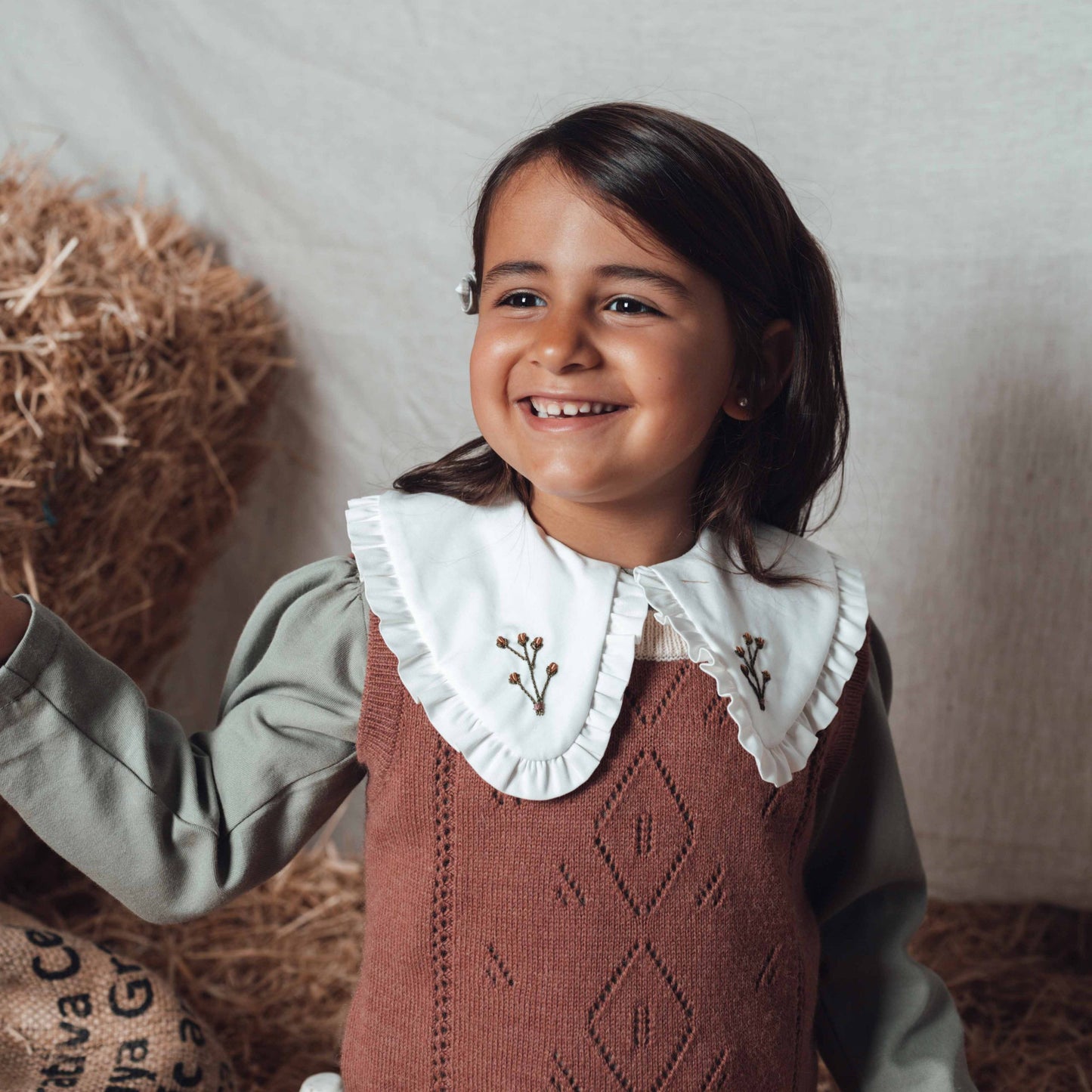 Terracotta vest with ivory collar