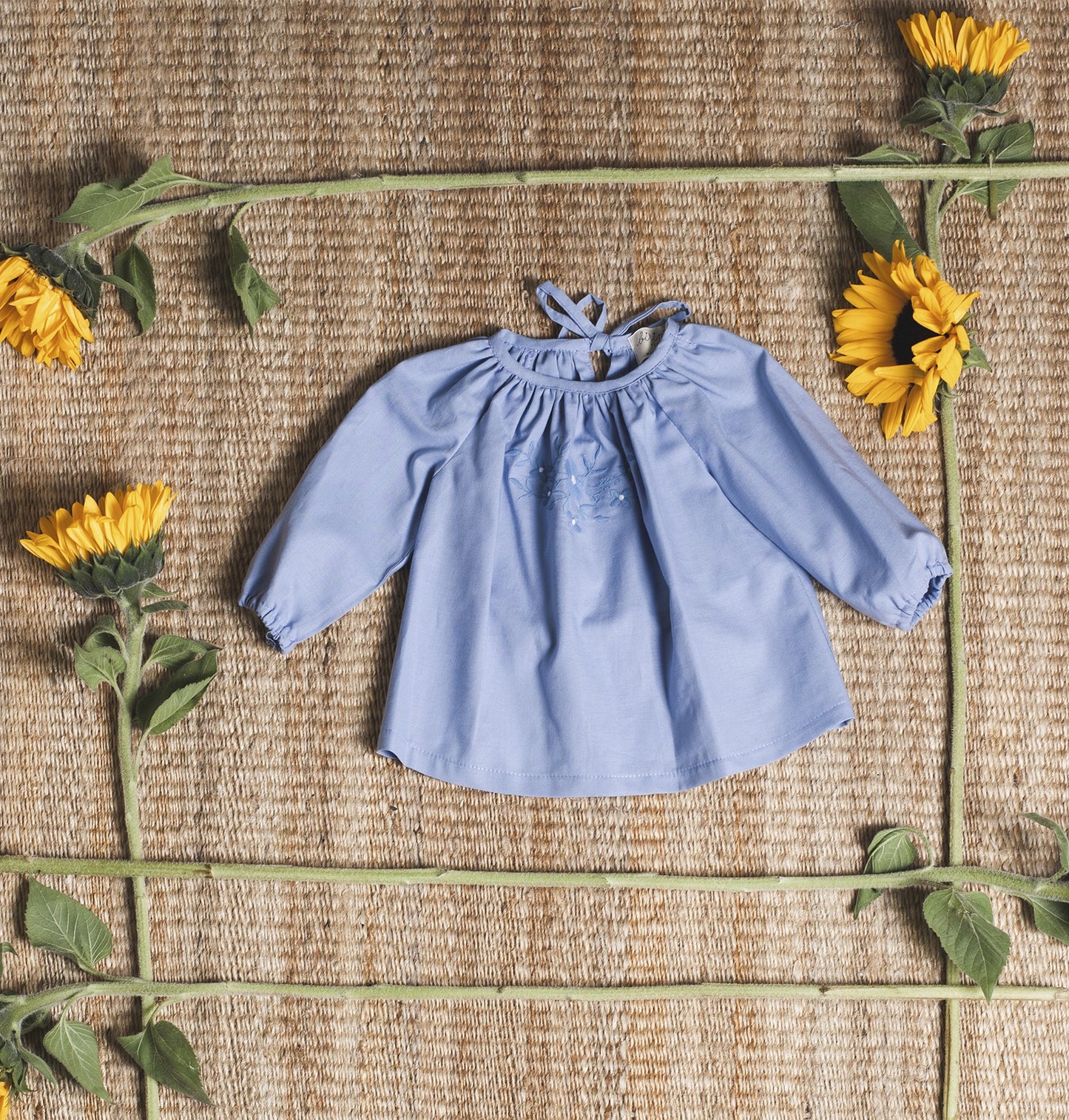 Bluish blouse with flower embroidered