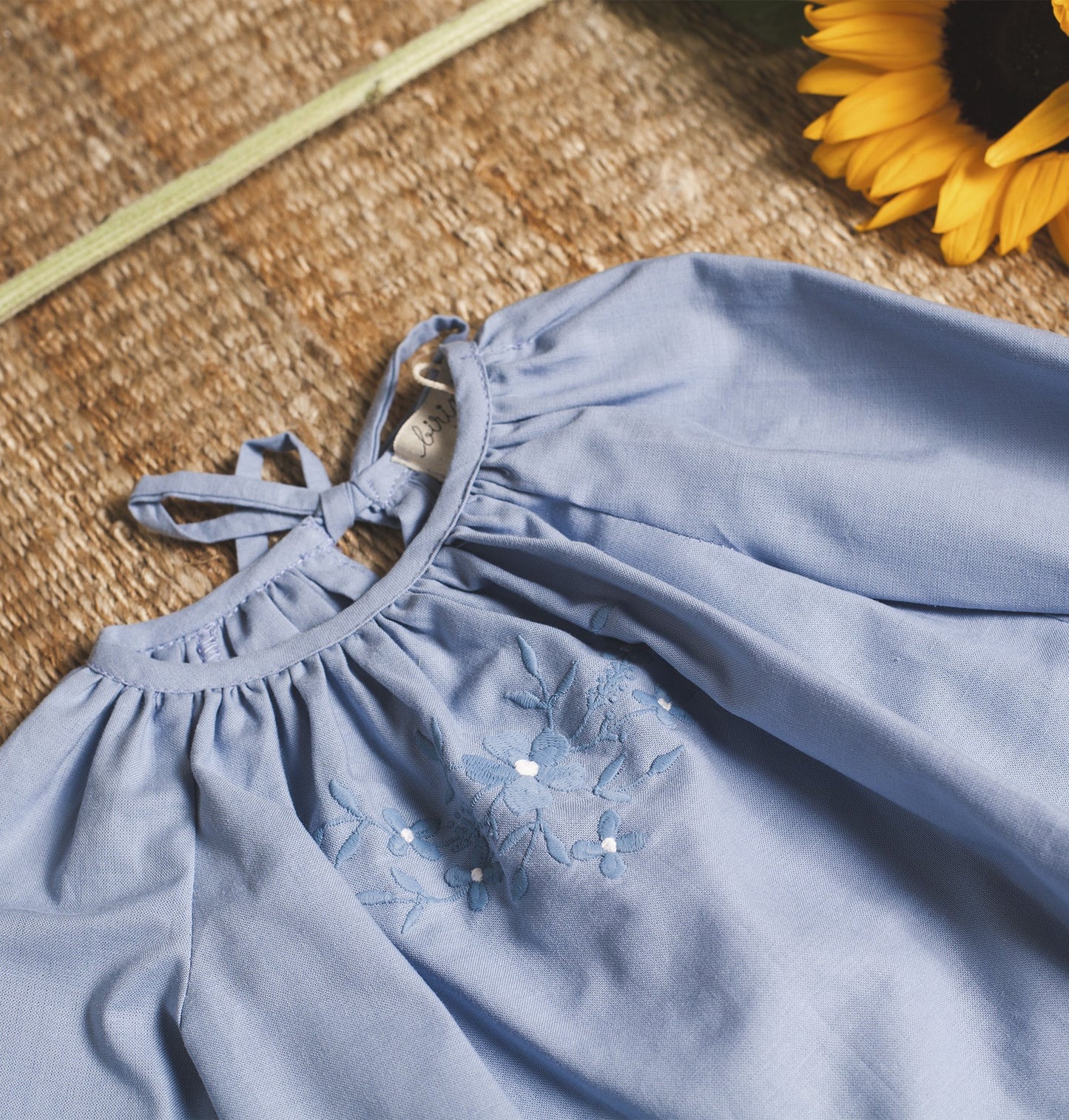 Bluish blouse with flower embroidered